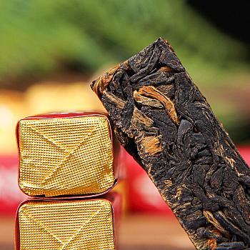 Yunnan Dian Hong tea, ancient tree sun-dried red tea, small gold bars, honey fragrance.